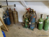 (SHOP 2) WELDING LOT; INCLUDES 9 OXYGEN CONTAINERS AND A ROLLING WELDING TANK HOLDER (HOLDS 2 TANKS)