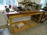 (WSHOP) WORKBENCH; SITS UPON 4 TREATED WOOD LEGS WITH THE TOP BEING MADE FROM AN OLD DOOR. IS IN