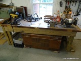 (WSHOP) WORKBENCH; SITS UPON 4 TREATED WOOD LEGS WITH THE TOP BEING MADE FROM AN OLD DOOR. IS IN