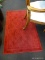 SMALL RED ACCENT RUG; NEEDS A GOOD CLEANING BUT IS OTHERWISE IN GOOD CONDITION. MEASURES 30 IN X 46