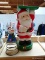 (B1A) SANTA BUTLER; MOTORIZED SANTA BUTLER WITH REMOTE. INCLUDES A TIN SNOWMAN WITH SPRING STYLE