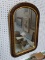 VINTAGE WALL MIRROR; THIS MIRROR IS FRAMED IN A ARCH TOP FRAME WITH ROUNDED BOTTOM CORNERS. THE