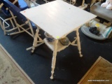 WHITE PAINTED SIDE TABLE; SQUARE TOP SITTING ON 4 SPINDLE LEGS WITH A LOWER SHELF. THIS TABLE SITS