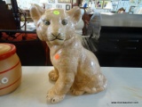 LION CUB STATUE; CERAMIC TAN COLORED LION CUB STATUE WITH BLACK PAINTED DETAILING AROUND THE EYES,