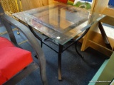GLASS TOP SIDE TABLE; SQUARE BEVELED GLASS TOP SITTING ON A BLACK METAL BASE WITH WOVEN STRETCHER