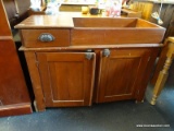 ANTIQUE DRY SINK; MADE OF SOLID REDDISH COLORED HARDWOOD, WITH A SINGLE DRAWER TO THE LEFT OF THE