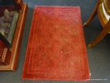 SMALL RED ACCENT RUG; NEEDS A GOOD CLEANING BUT IS OTHERWISE IN GOOD CONDITION. MEASURES 30 IN X 46