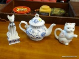 3 PIECE LOT; INCLUDES A WHITE PORCELAIN TEAPOT, A CAT THEMED TEAPOT, AND A EGYPTIAN CAT THEMED