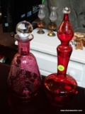 ETCHED CRANBERRY GLASS LOT; INCLUDES 2 DECANTERS. 1 MEASURES 12 IN TALL AND 1 MEASURES 10 IN TALL