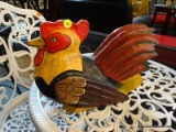 DECORATIVE CHICKEN; ORANGE RED AND BLACK. MEASURES 13 IN LONG. MADE IN THE PHILIPPINES.