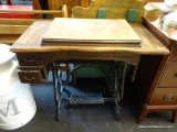 ANTIQUE SEWING MACHINE AND CONSOLE TABLE; WOODEN TABLE TOP CONTAINING AN ANTIQUE BLACK SEWING