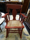 CANE SEAT ROCKING CHAIR; RED PAINTED DISTRESSED ROCKING CHAIR WITH FIDDLEBACK AND INTACT CANE SEAT.