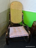 CANE BACK/SEAT ROCKER WITH AMERICANA PLAID TIE-ON CUSHION; GLOSSY DARK STAINED WOODEN FRAME WITH