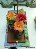 (TBL) ASSORTED LOT; INCLUDES 3 ARTIFICIAL FLOWERS IN POTS, A CONDIMENT CONTAINER CADDY, AND FLOOR