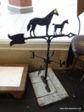 VTG HORSES BLACK IRON WEATHER VANE; IS MOUNTED ON A BLUE WOODEN BASE AND IS IN EXCELLENT CONDITION.