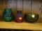 3 PIECE LOT; INCLUDES A 3 FOOTED DIAMOND PATTERN DISH, A RED CANDLE SHADE, AND A GREEN GLASS CANDLE