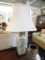 TABLE LAMP; 1 OF A PAIR OF GREEN FLORAL TABLE LAMPS WITH WHITE RECTANGULAR SHADES AND BRASS FINIALS.