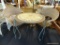 WICKER AND IRON PATIO SET; INCLUDES 2 CHAIRS AND ROUND TOP TABLE. ROUND TABLE HAS LEAF PATTERNED