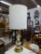 TABLE LAMP; 1 OF A PAIR OF GOLD AND CREAM TONED TABLE LAMPS WITH TALL ROUND SHADES AND BRASS