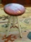 VINTAGE PIANO STOOL; HAS A RED LEATHER TOP (HAS SOME CHIPPING AS COMES WITH AGE) AND A WHITE PAINTED