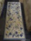 BLUE AND YELLOW FLORAL RUG RUNNER; FEATURES LIGHT BLUE, DARK BLUE, AND YELLOW FLOWERS ON A VINE,