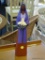 POTTERY SCULPTURE OF A WOMAN HOLDING LILY BLOSSOMS; POTTERY SCULPTURE OF WHAT APPEARS TO BE A NATIVE