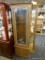 GLASS FRONT, WOOD FRAME GUN CABINET; STACKED DOOR WOODEN GUN CABINET. TOP DOOR CONTAINS A GLASS