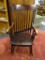 DARK STAINED ROCKER; DARK STAINED, SLAT BACK ROCKER WITH SCROLL ARMS THAT ARE SUPPORTED BY TWO