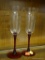 PAIR OF CHAMPAGNE FLUTES; RED STEMMED CHAMPAGNE FLUTES. MEASURE 8.5 IN.