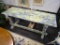 HAND PAINTED TABLE; TABLE IS HAND PAINTED WITH A GRAY, BLUE, AND YELLOW BRUSHSTROKE DESIGN. THIS