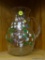HAND PAINTED PITCHER; FEATURES WHITE, BLUE, RED, AND PURPLE FLOWERS ON A VINE THAT WRAPS AROUND THE