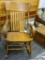 BANISTER BACK WOODEN ROCKER; ROUNDED ARMS SUPPORTED BY THREE SPINDLES. TWO SPINDLES ALSO RUN ACROSS