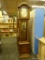 PIPER GRANDFATHER CLOCK; DARK WOOD GRANDFATHER CLOCK. LOWER DOOR HAS A BRASS MOCK KEY PULL. UPPER