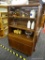 RETRO CUPBOARD; THIS PIECE CONTAINS TWO SLIDING GLASS PANELS ON TOP THAT OPEN TO ACCESS TWO WOODEN