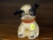 VINTAGE CAST IRON DOG BANK; CAST IRON COIN BANK THAT RESEMBLES A BLACK AND WHITE DOG WITH A RED