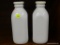 CRATE & BARREL MILK BOTTLES; PAIR OF WHITE PORCELAIN MILK BOTTLES WITH SILICONE LIDS. BOTTLES ARE