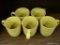 SET OF COFFEE MUGS; SET OF 5 MUSTARD COLORED COFFEE MUGS WITH RAISED LEAF PATTERN. THE RIM, HANDLE,