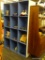 TWELVE CUBE SHELF; LIGHT BLUE AND WHITE PAINTED SHELF, CONTAINING TWELVE STORAGE CUBES. MEASURES 48