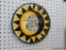 HAND PAINTED SUN MIRROR; FRAME OF MIRROR IS PAINTED IN ORANGE, YELLOW, BLACK, AND GOLD, AND HAS THE