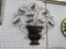 WROUGHT IRON WALL DECORATION; BLACK AND COPPER TONED WALL DECORATION FEATURES A PLANTER WITH SCROLL