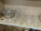 PARTIAL SHELF LOT OF ASSORTED GLASSWARE; THIS LOT CONTAINS 7 GLASS MUGS AND 5 SAUCERS, 8 STEMMED
