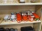 3/4 SHELF LOT; INCLUDES VARIOUS COFFEE MUGS, JOY AND PEACE SHELF HANGERS, ETC.
