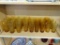 PARTIAL SHELF LOT OF AMBER DRINKING GLASSES; THIS 27 PIECE LOT INCLUDES THREE SIDES OF AMBER COLORED
