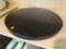 GRANITE TABLE TOP; BLACK GRANITE WITH FLAKES OF LIGHT GRAY. HAS AN 18 IN DIAMETER.