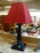 WOODEN TABLE LAMP; BLACK WOODEN TABLE LAMP WITH SQUARE BASE AND RED, SQUARE SHADE. MEASURES 22 IN