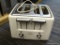 HAMILTON BEACH TOASTER; HOLDS UP TO 4 SLICES AND HAS BEEN HARDLY USED. IS WHITE AND SILVER IN COLOR.