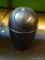 BLACK TRASH CAN; SMALL BLACK TRASH CAN WITH REVOLVING TOP LID. MEASURES 16 IN TALL