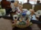ROCKING PORCELAIN HORSE; IS GOLD, PURPLE, BROWN, AND WHITE IN COLOR. MEASURES 13 IN X 13 IN