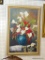 LARGE FLORAL STILL LIFE IN GOLD COLORED FRAME; SHOWS A BLUE AND GOLD TONED VASE FILLED WITH A