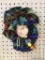 HAND PAINTED WALL HANGING; THIS PIECE IS HAND PAINTED WOMAN'S FACE WITH FAUX PEARLS HANGING DOWN AND